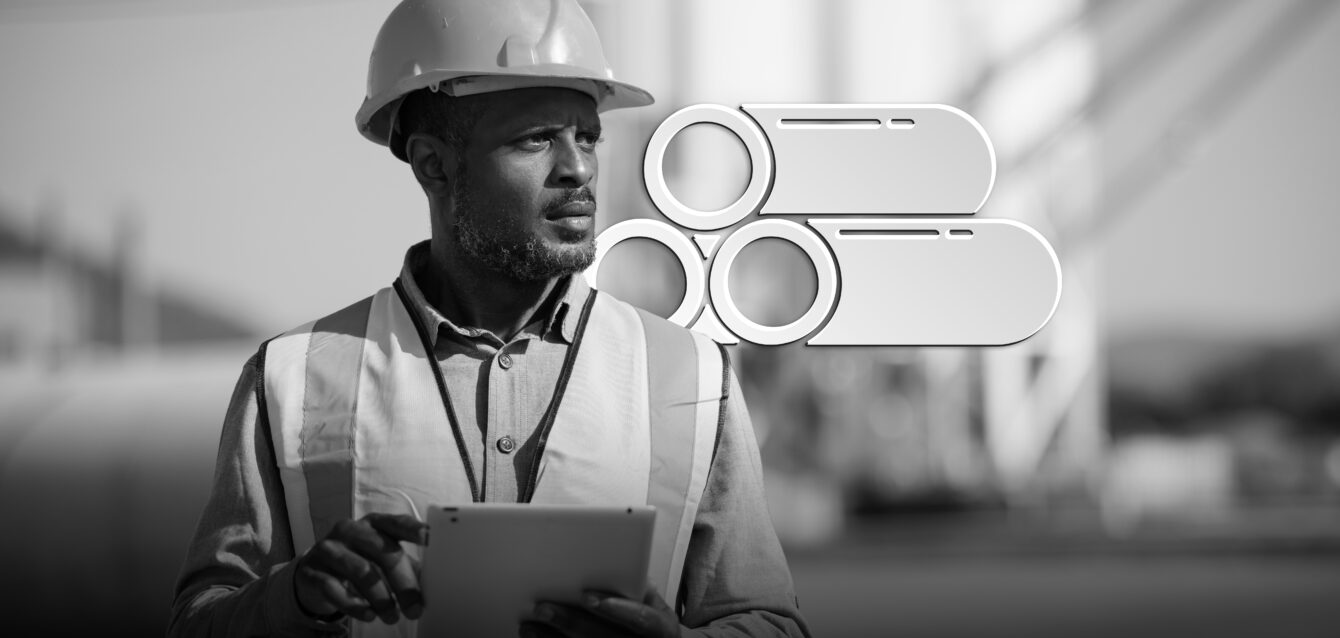 Portrait of male engineer with hardhat using digital tablet while working on his work site