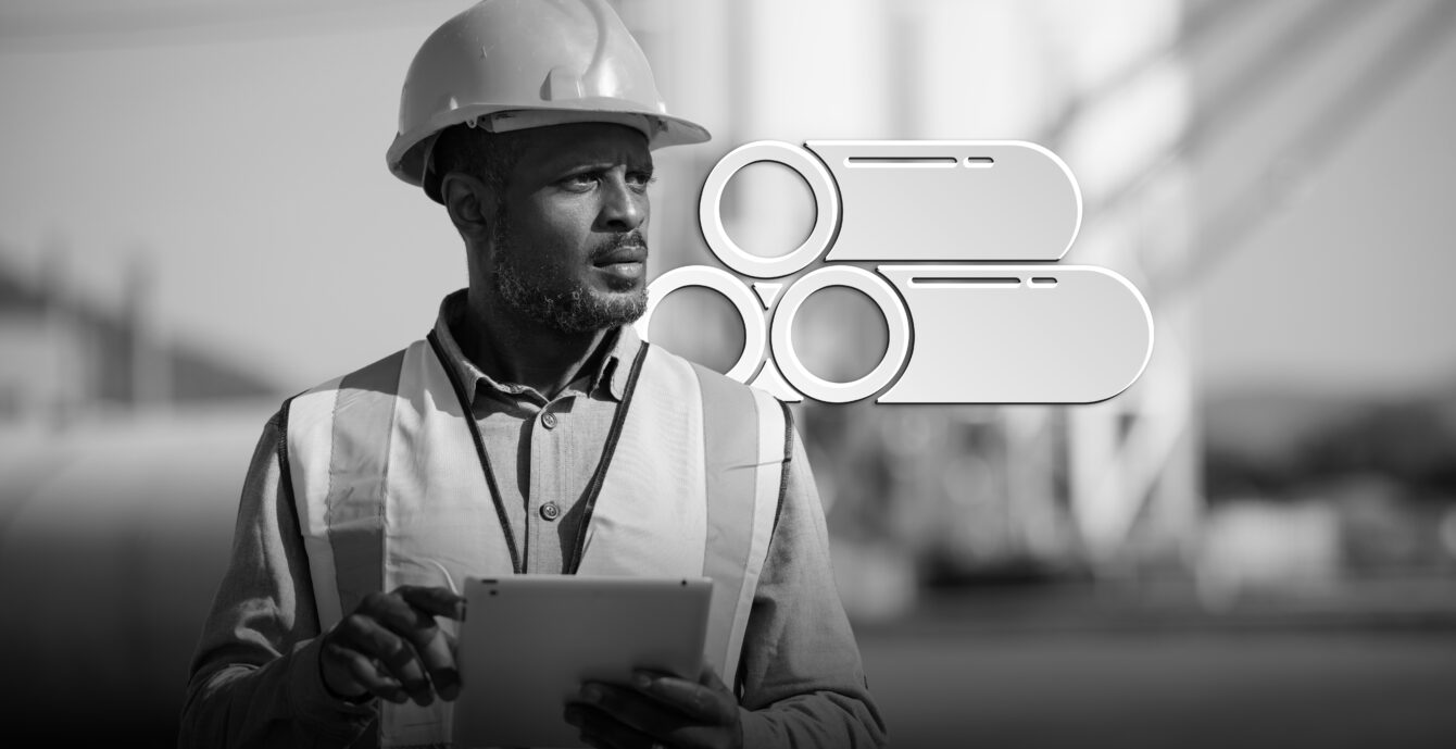 Portrait of male engineer with hardhat using digital tablet while working on his work site