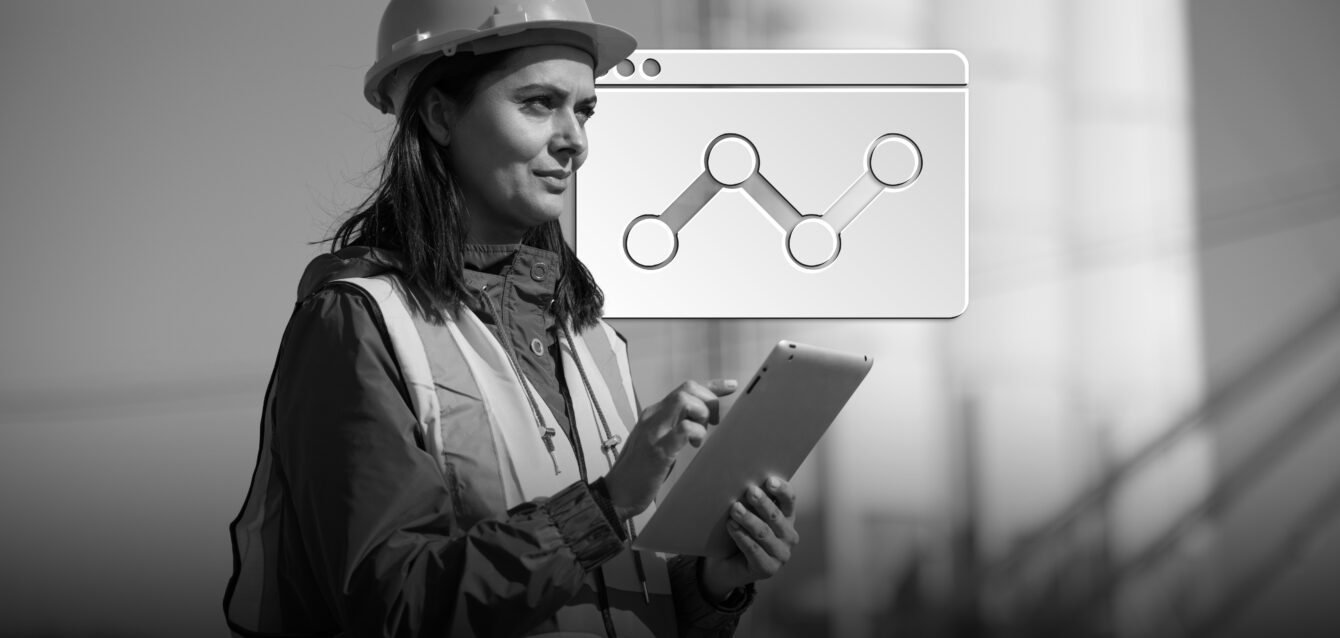 Portrait of female engineer with hardhat using digital tablet while working on her work site