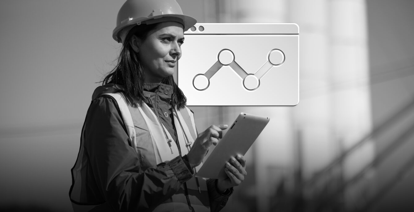 Portrait of female engineer with hardhat using digital tablet while working on her work site