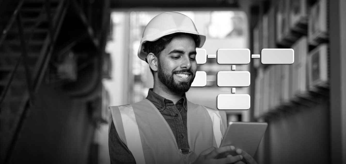 Portrait of young engineer worker, man in helmet and vest using tablet computer, smiling, checking production figures
