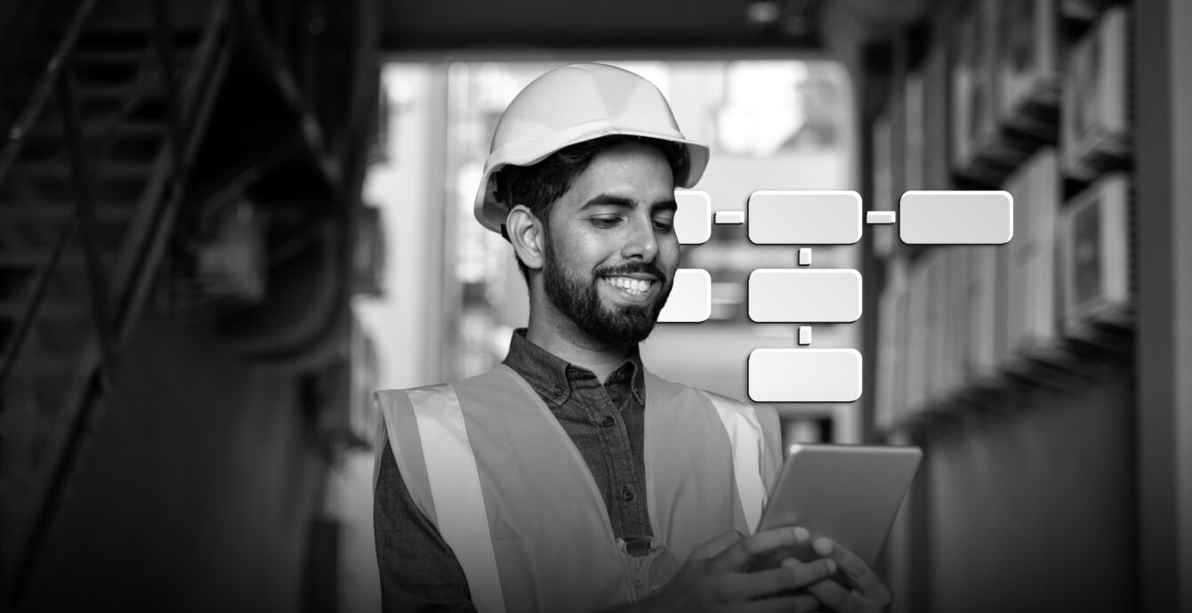 Portrait of young engineer worker, man in helmet and vest using tablet computer, smiling, checking production figures